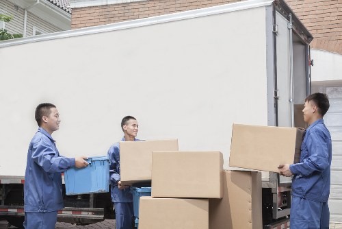 Furniture and boxes being loaded into a moving van in West Hampstead