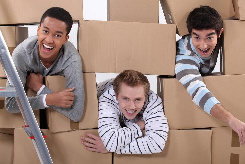 Commercial office moving team preparing furniture for transport in West Hampstead