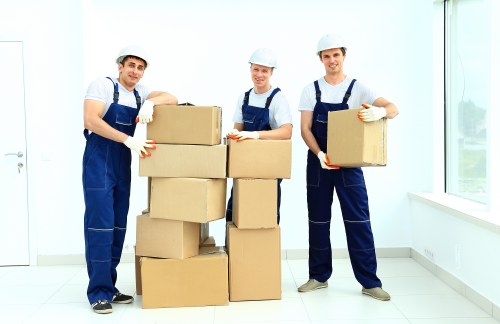 Professional removals crew organizing and protecting furniture in West Hampstead