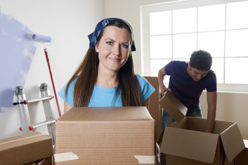 Movers carrying furniture through a Westhampstead property